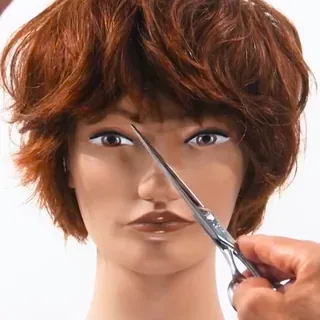 Course still: a short textured cut with a fringe being checked with shears on a mannequin